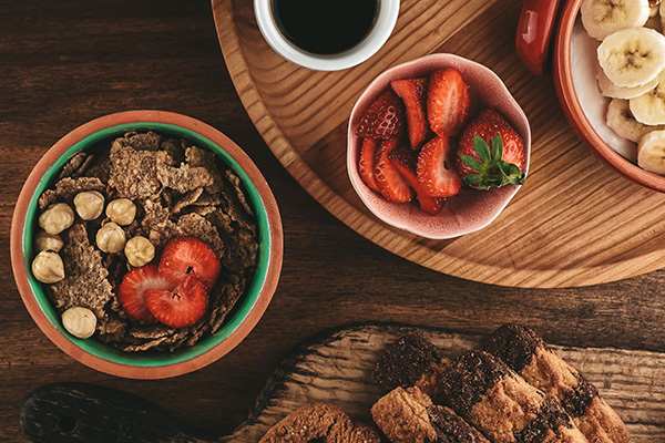 different types of healh foods on wood plates and bowls