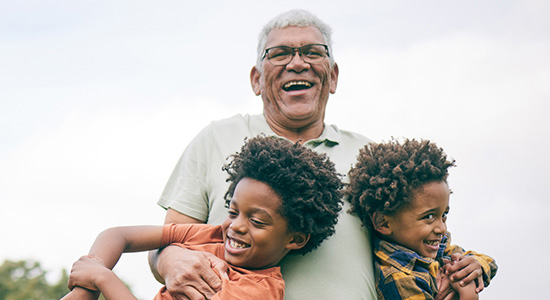 Grandpa with two grandsons in arms